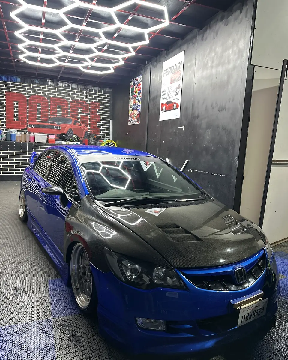 Blue and black sedan in the Auto Palette detailing bay